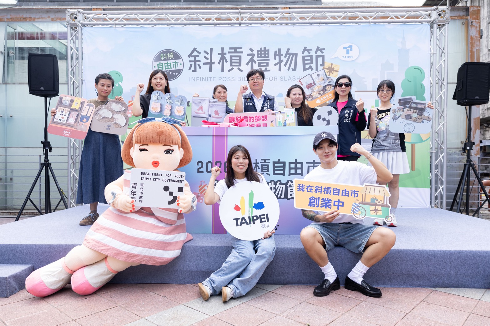 相關圖片 臺北市政府青年局舉辦斜槓禮物節記者會，集結50家青創品牌，展現青創能量，插畫家H.H.先生與人氣角色「美美」也出席活動並為市集設計週邊提袋。